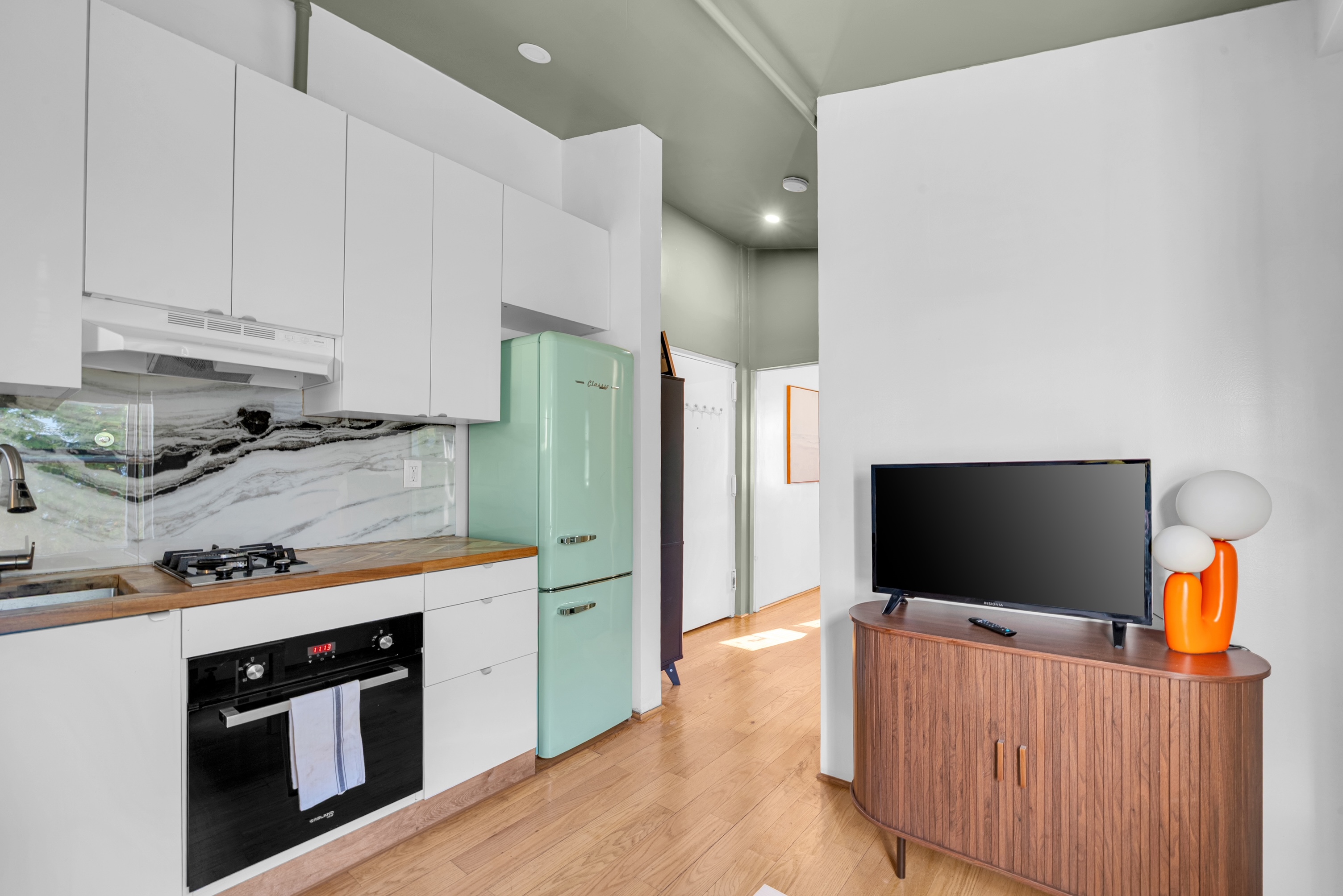 The Beach House — kitchen with retro refrigerator and smart TV
