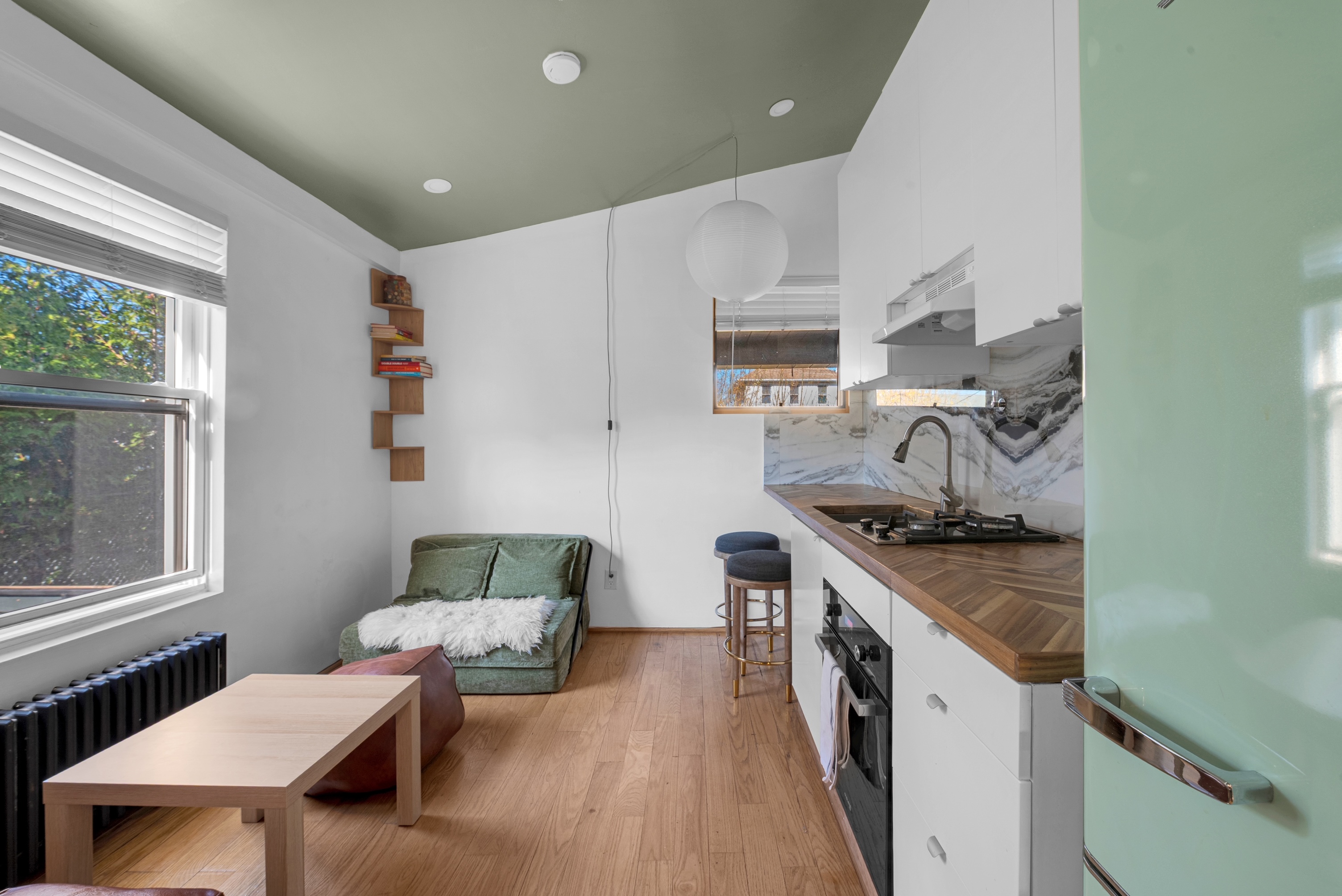 The Beach House — living area with sofa and full kitchen