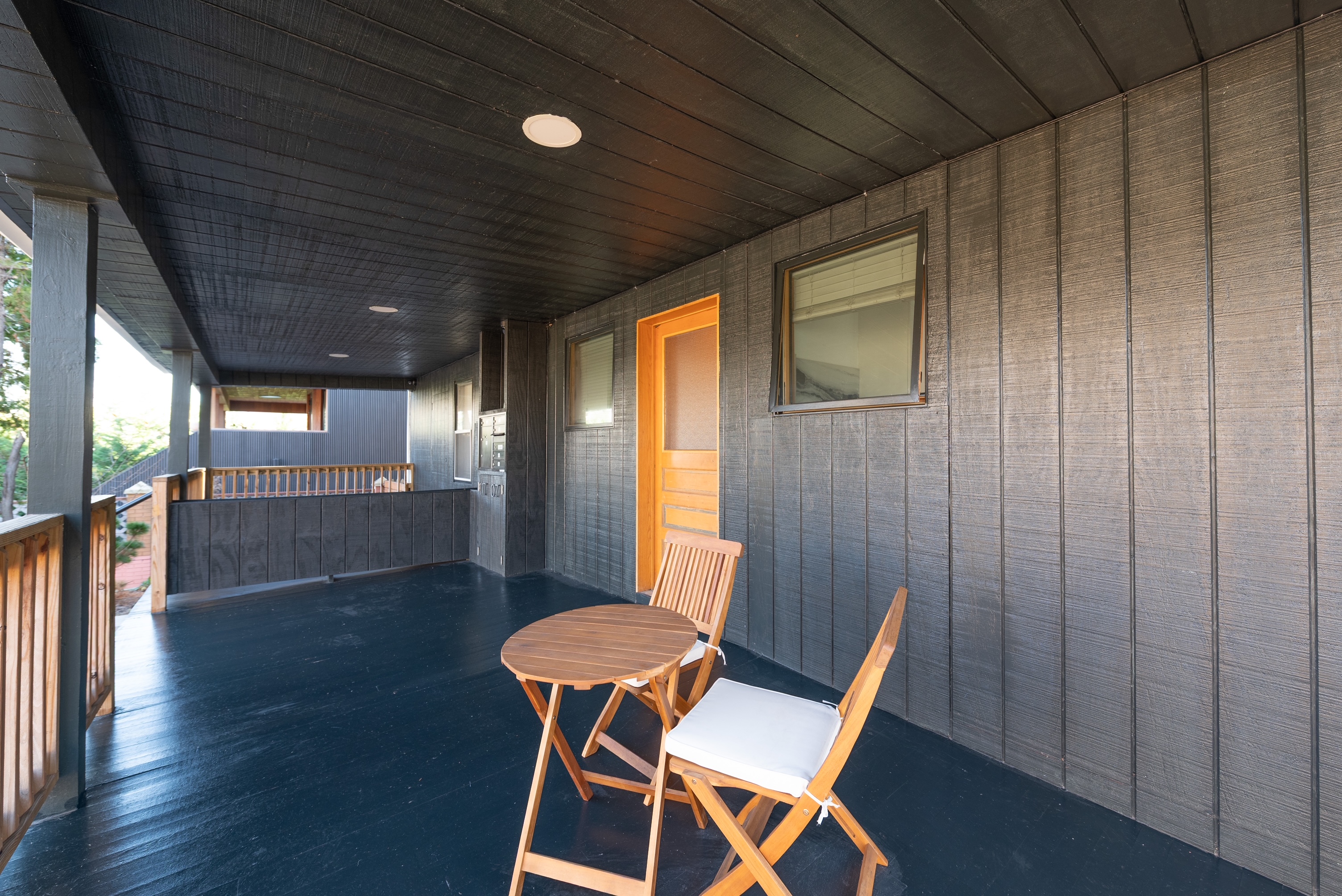 Shared covered porch with bistro seating